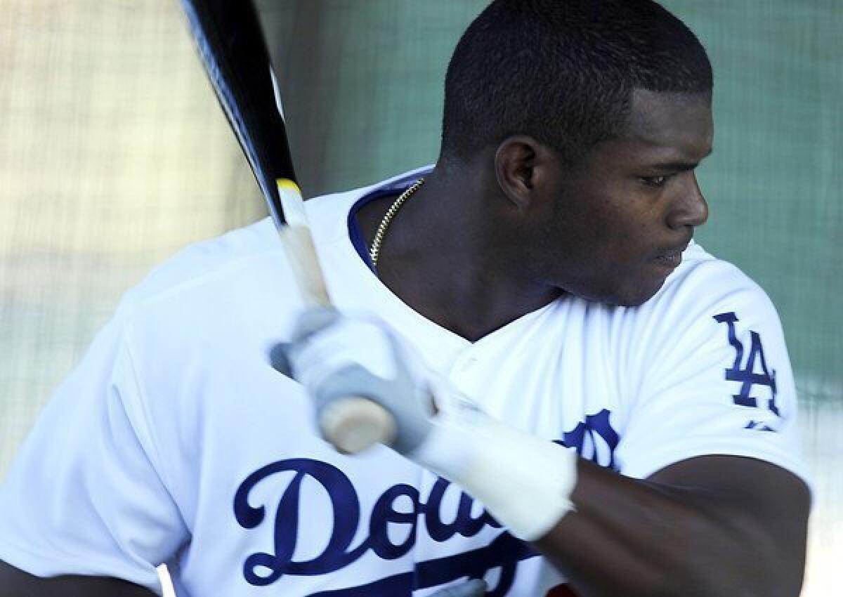 Dodgers outfielder Yasiel Puig works on batting technique during a workout in spring training.