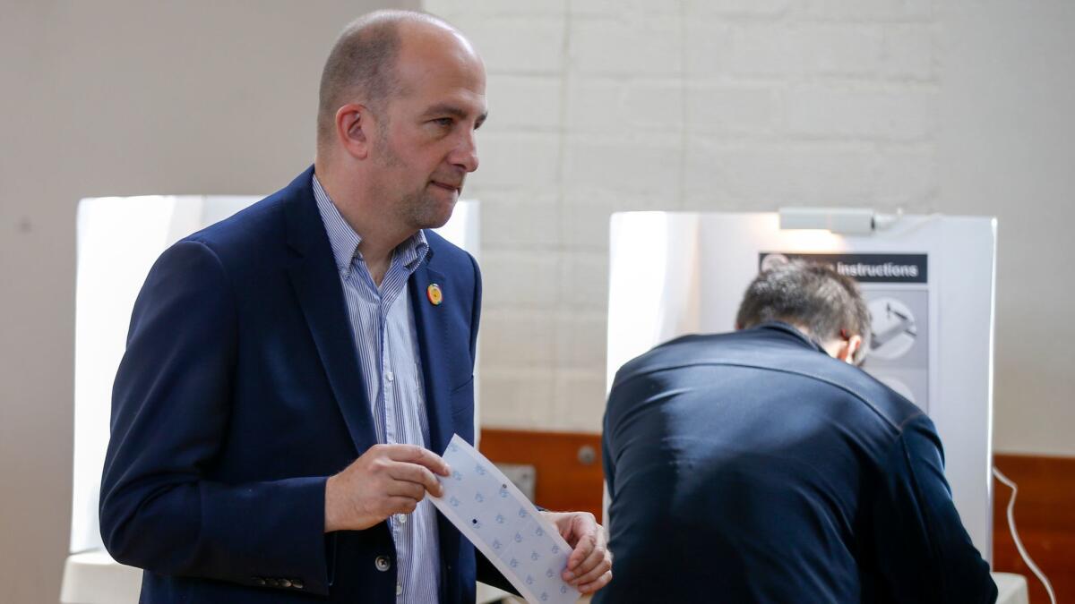 L.A. Unified school board President Steve Zimmer casts his ballot Tuesday at the Hollywood Recreation Center. He finished ahead, but still will face a runoff in May.