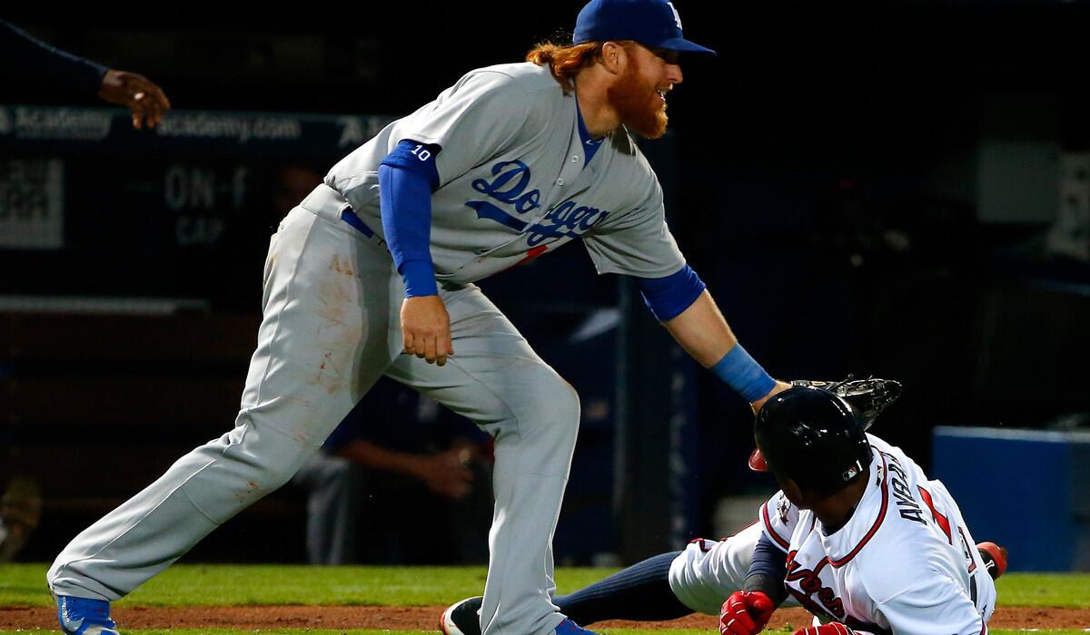 The Braves' Erick Aybar is tagged out by the Dodgers' Justin Turner in the fourth inning of an April 20 game in Atlanta.