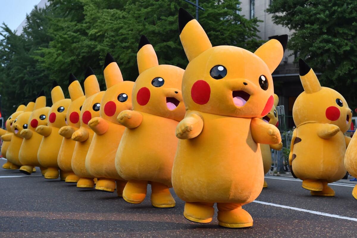 Costumed performers dressed as Pikachu, a popular character from "Pokemon," line up during a promotional event at the Yokohama Dance Parade in Yokohama, Japan, in this file photo from Aug. 2, 2015.