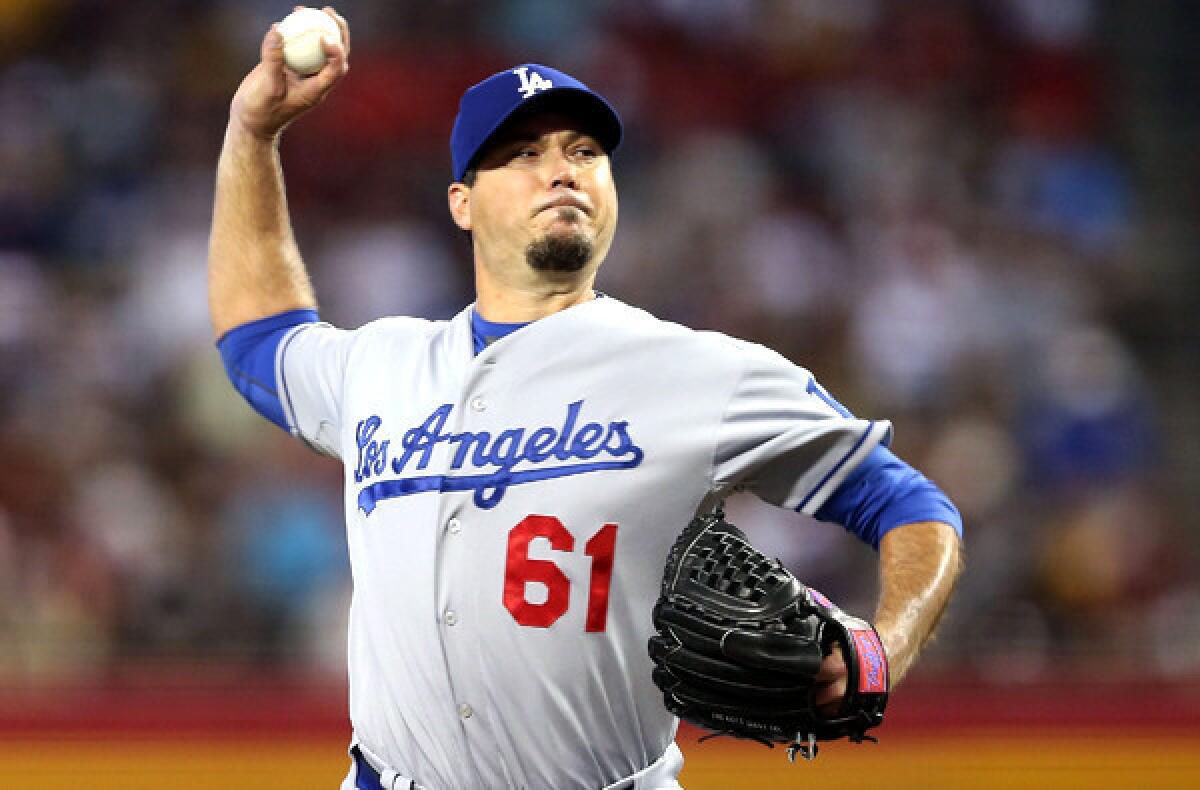 Dodgers starting pitcher Josh Beckett delivers a pitch against Diamondbacks on Sunday afternoon in Phoenix.