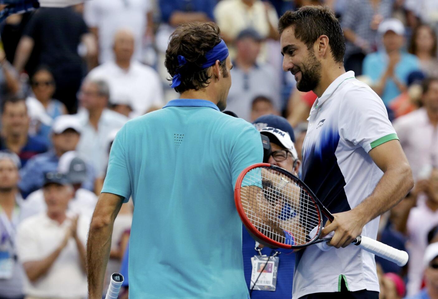 Marin Cilic shakes hands with Roger Federer.