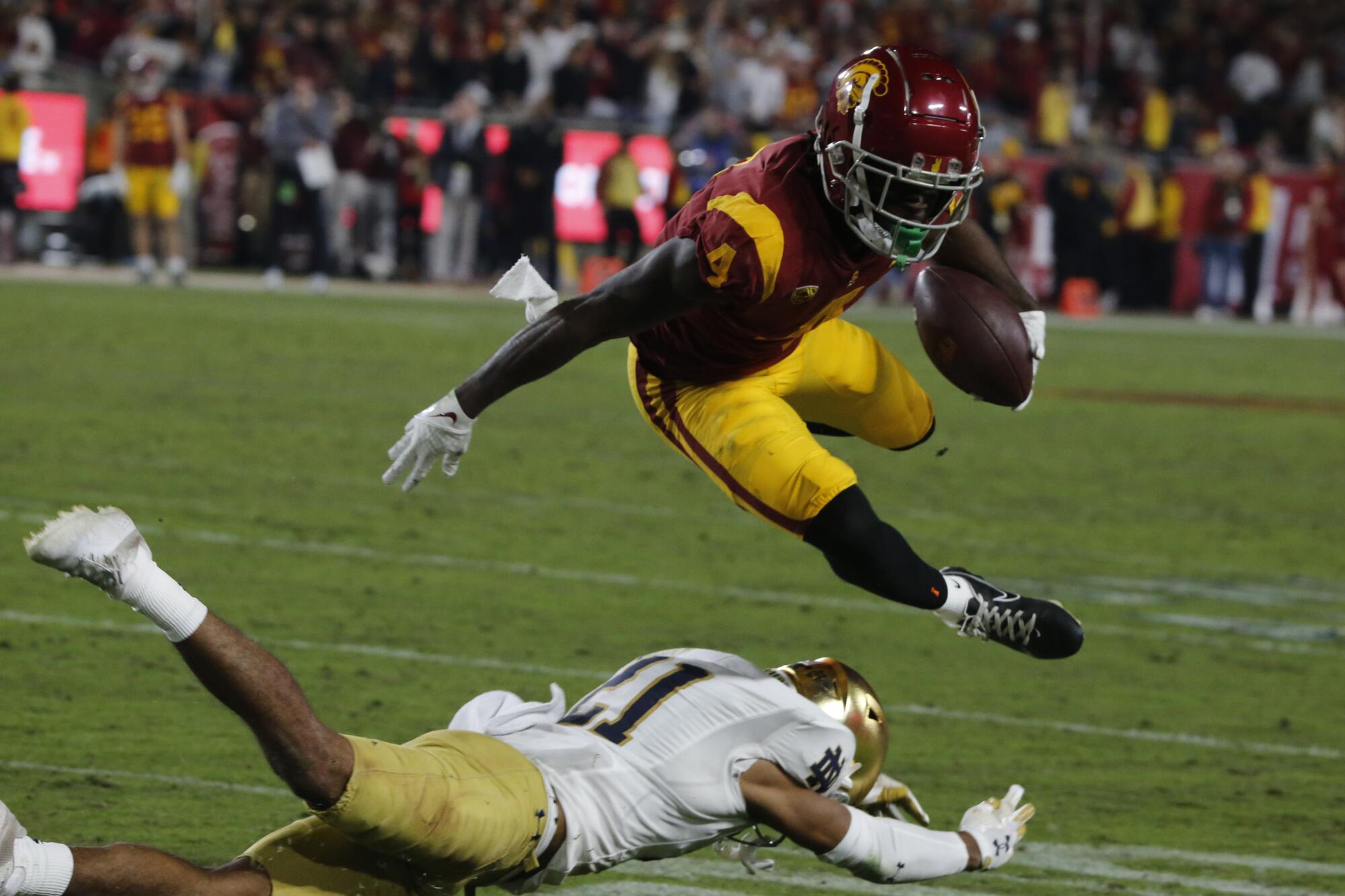 USC receiver Mario Williams hurdles over Notre Dame cornerback Jaden Mickey after making a catch in the third quarter.