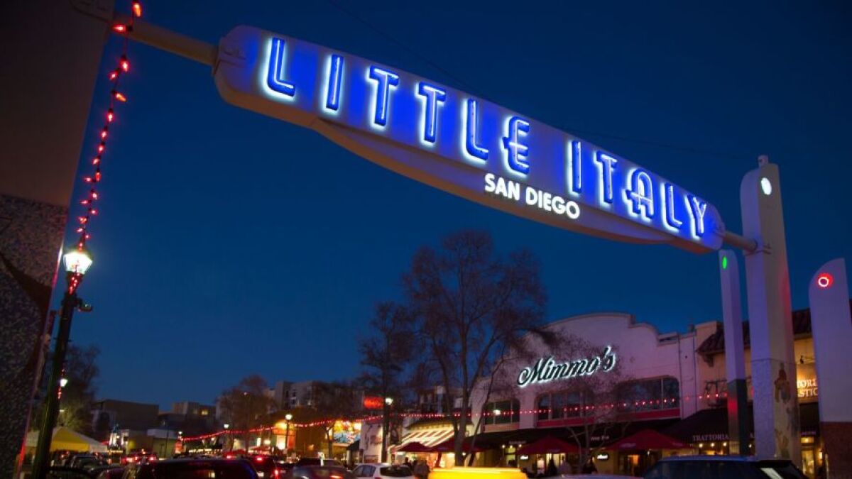 Weekend traffic and visitors fill India Street near the lighted Little Italy sign. 