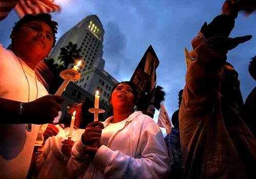Supporters hold candles during a Speak Out For Realistic, Rational Immigration Reform rally in Downtown Los Angeles Monday.