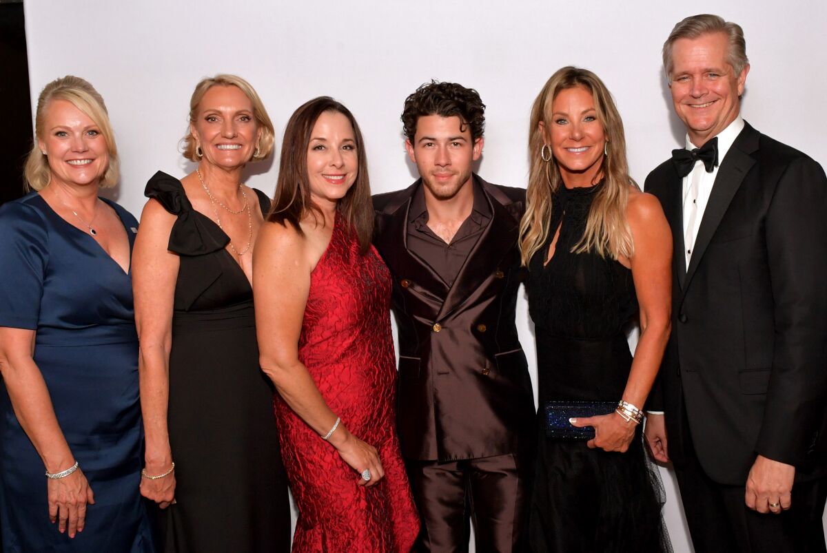 Kristin J. Bertell, from left, Annette M. Walker, Lisa Argyros, Nick Jonas, Stephanie Argyros and Robert Stone.