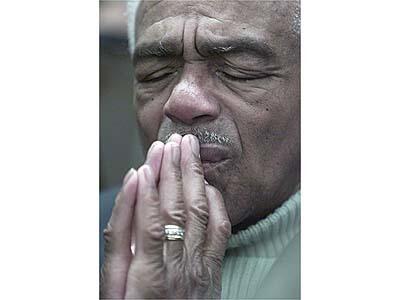 Daniel Morgan prays during Police Commission meeting before its announcement of 4-1 vote against a second term for Chief Bernard C. Parks.