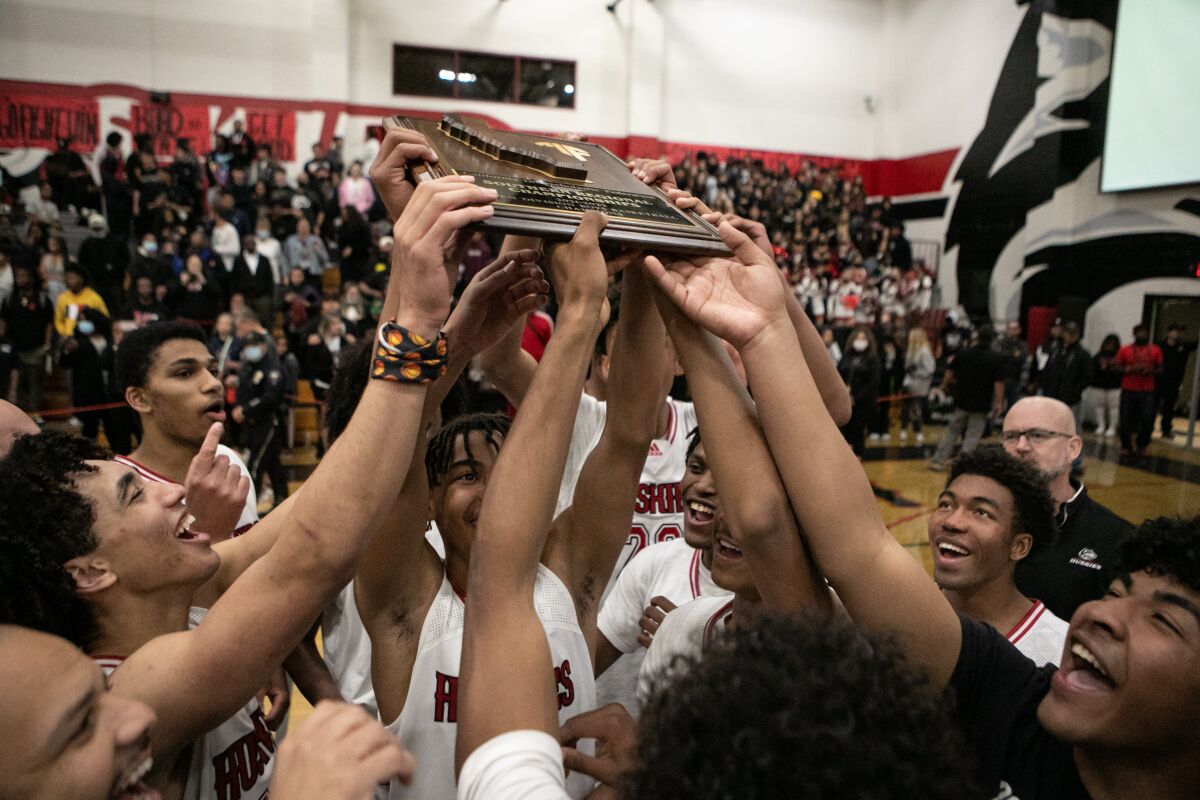 Corona Centennial boys basketball team celebrates winning a regional basketball title