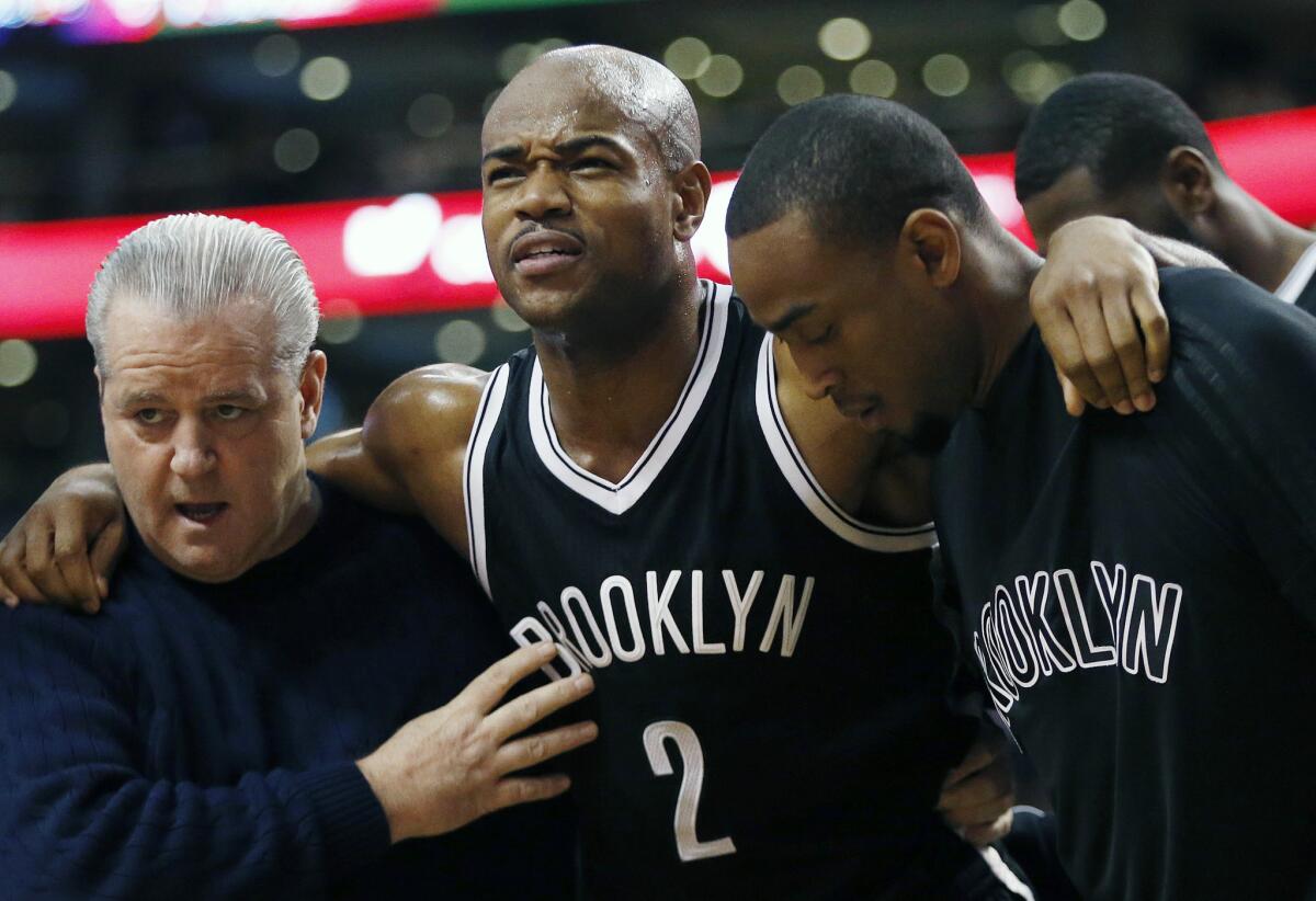 Nets guard Jarrett Jack (2) is helped off the court after being injured during the third quarter.