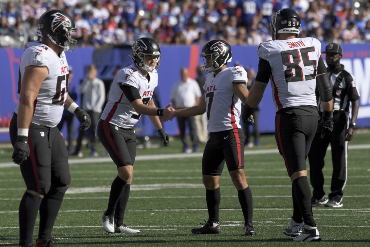 Atlanta Falcons kicker Younghoe Koo (7) celebrates with placeholder Cameron Nizialek (9) after kicking the extra point to tie the game during the second half of an NFL football game against the New York Giants, Sunday, Sept. 26, 2021, in East Rutherford, N.J. (AP Photo/Bill Kostroun)