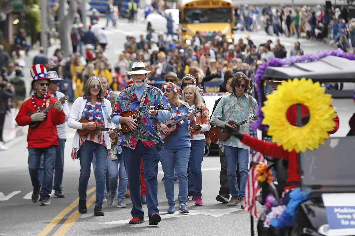 The ukulele strumming group of Laguna Beach Seniors walk in the 56th annual Patriots Day Parade in Laguna Beach on Saturday.