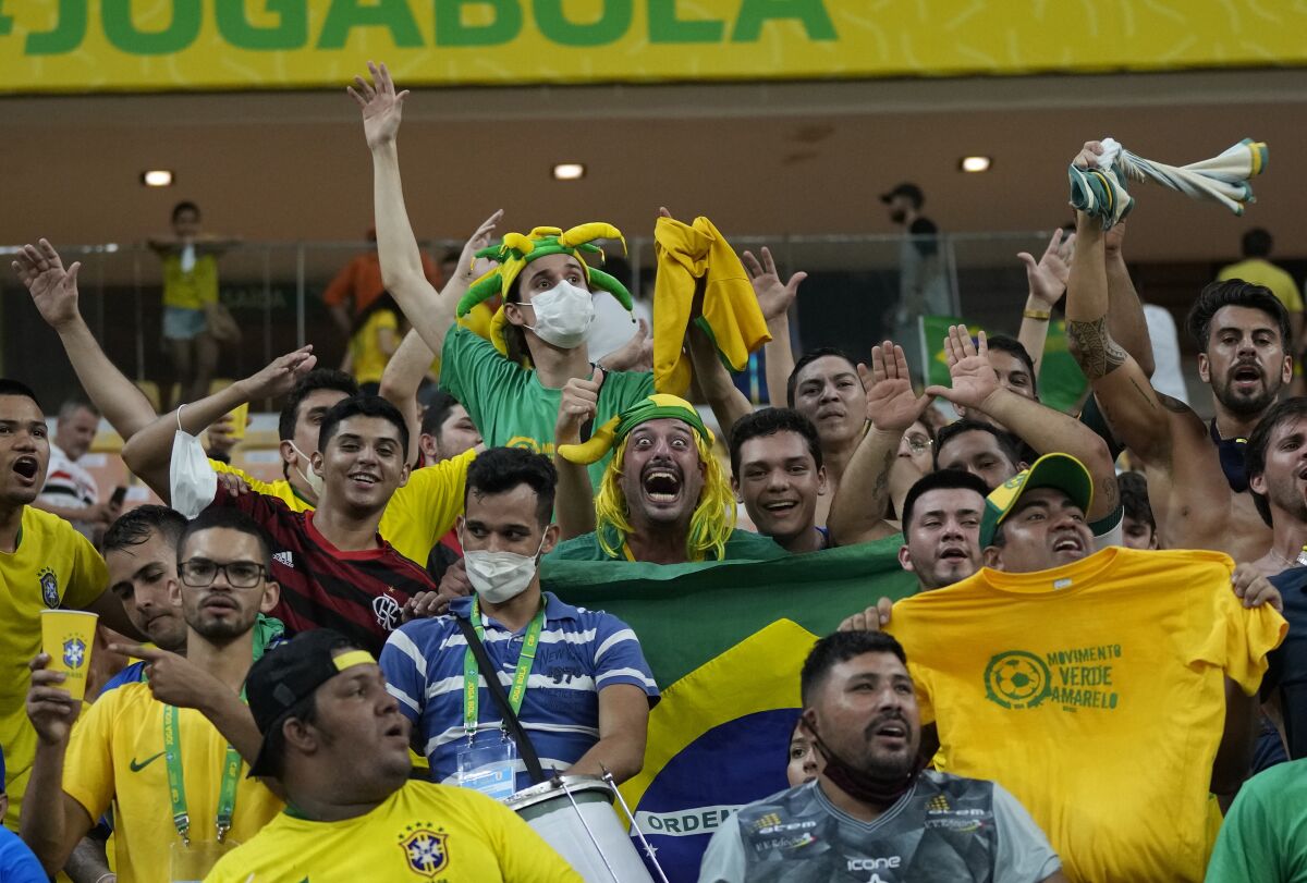Fans celebrate their team's win over Uruguay at the end of a qualifying soccer match for the FIFA World Cup Qatar 2022 at Arena da Amazonia in Manaus, Brazil, Thursday, Oct.14, 2021. Brazil won 4-1. (AP Photo/Andre Penner)