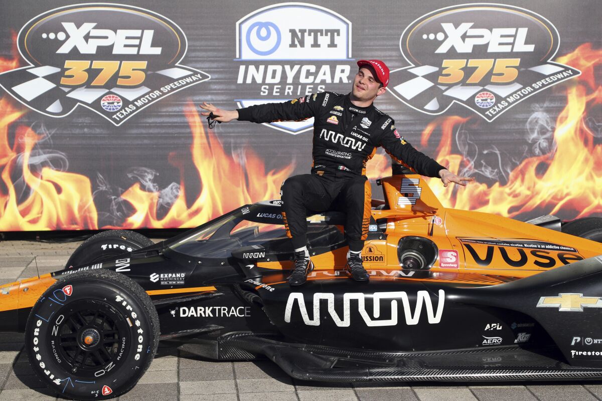 FILE - Pato O'Ward celebrates his victory at an IndyCar Series auto race at Texas Motor Speedway on Sunday, May 2, 2021, in Fort Worth, Texas. IndyCar is on a high as it begins its season with young talent capable of carrying the series into the future. But Colton Herta and is again the mix of Formula One conversations and Pato O’Ward already has one foot out the door. (AP Photo/Richard W. Rodriguez, File)