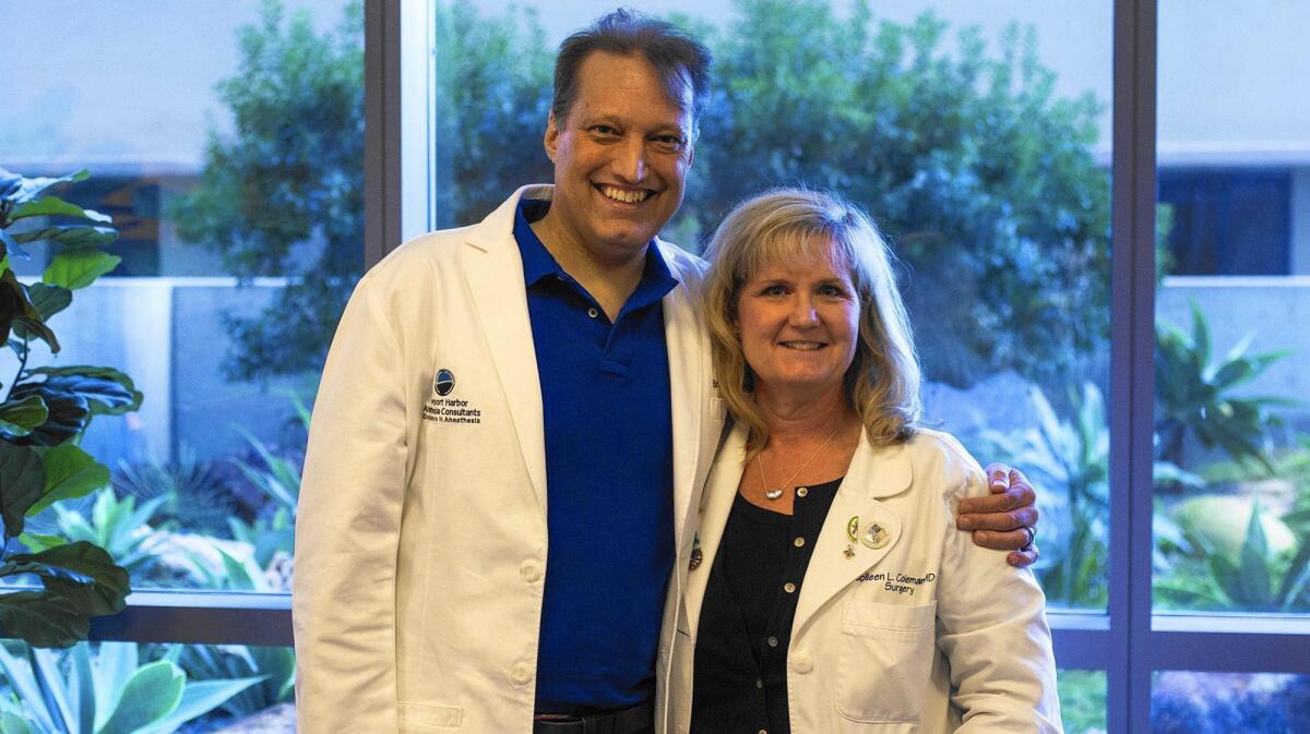 Hoag Hospital’s Dr. Brian Dunn, an anesthesiologist, and Dr. Colleen Coleman, a general surgeon, pose at the Newport Beach hospital. Coleman donated one of her kidneys to Dunn, her colleague of about 12 years.