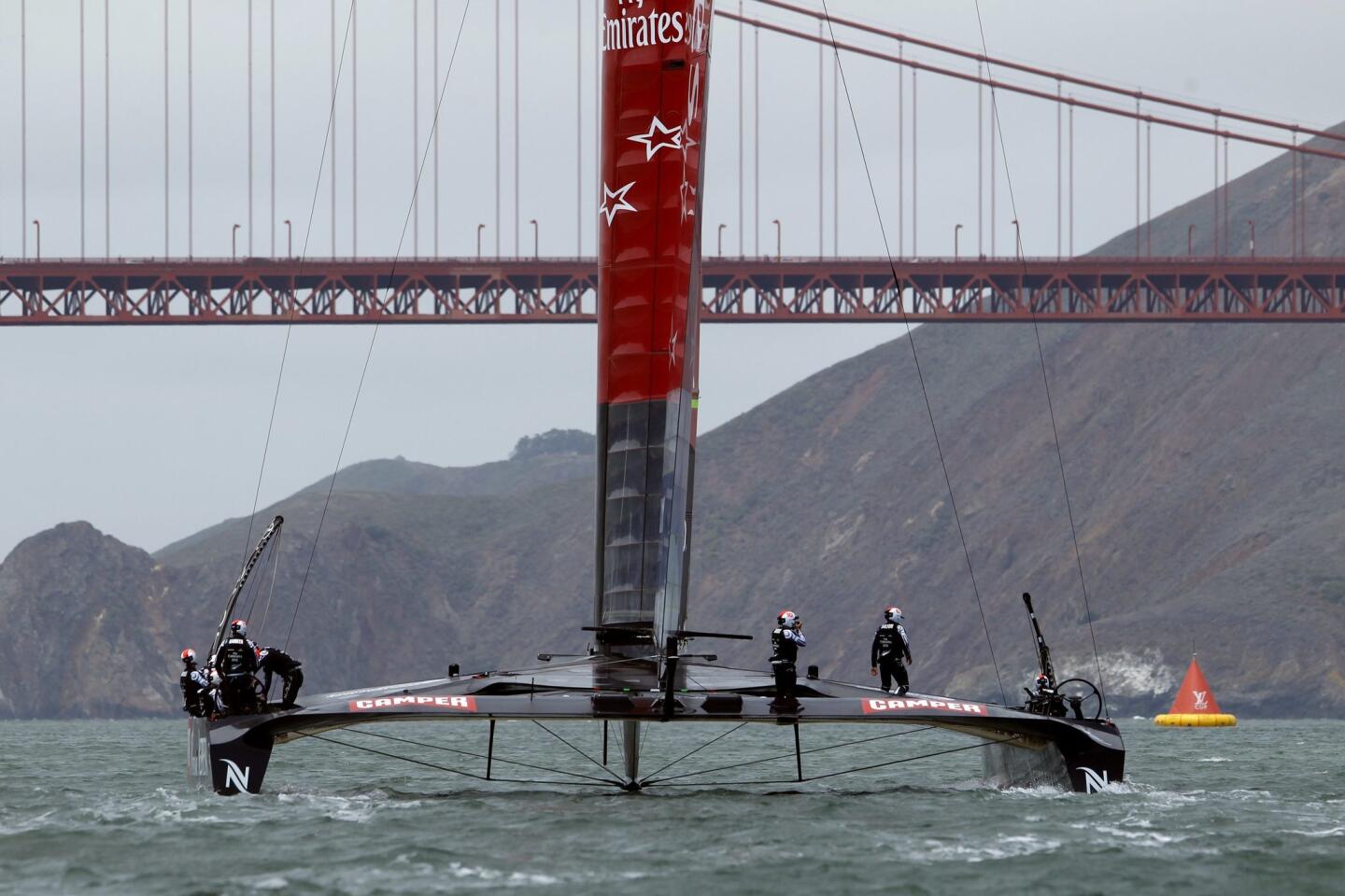 Emirates Team New Zealand sails toward the Golden Gate Bridge during the round robin one yacht races of the Luis Vuitton Cup challenger series in the 34th America's Cup in San Francisco