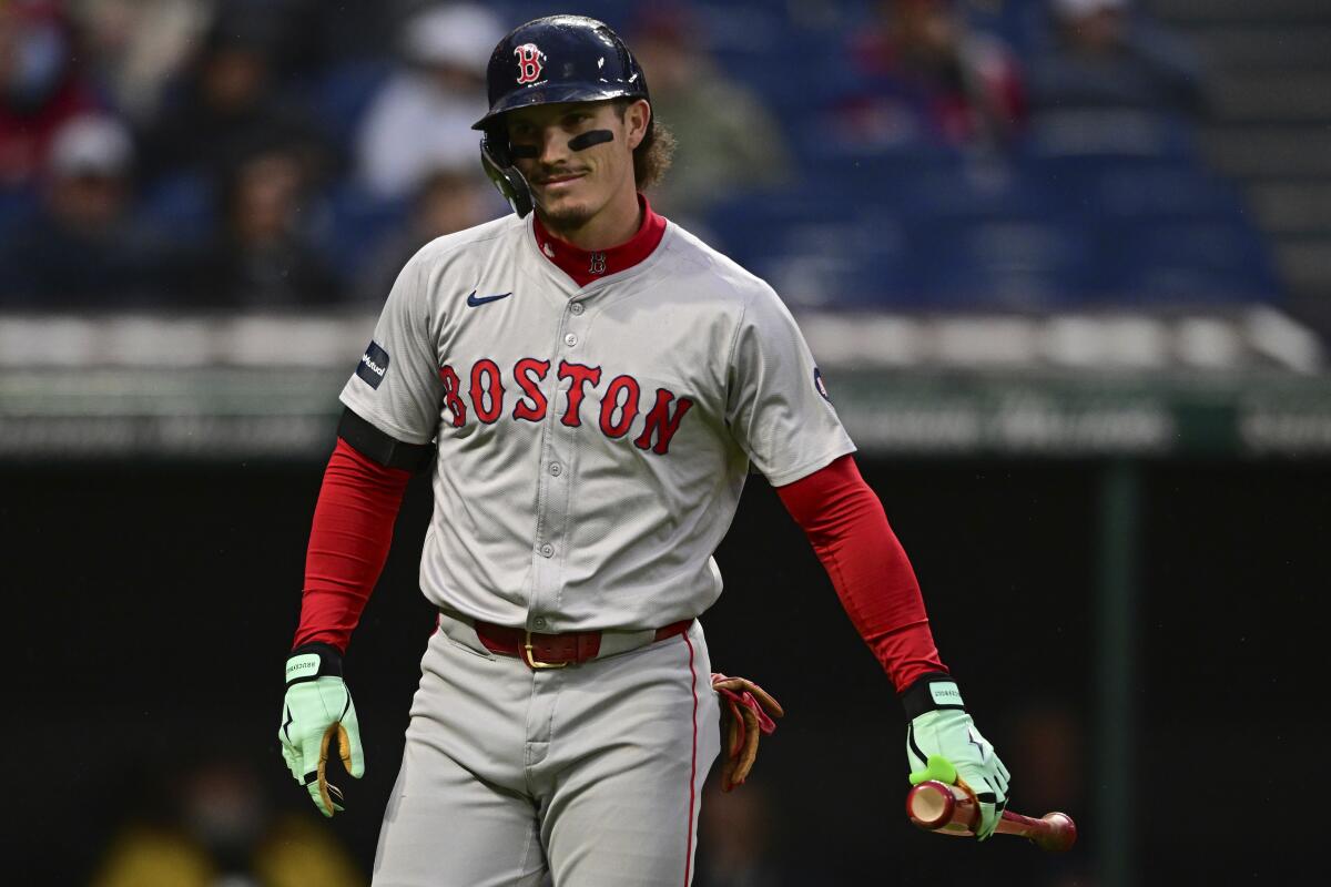 Red Sox outfielder Jarren Duran is holding his bat after striking out