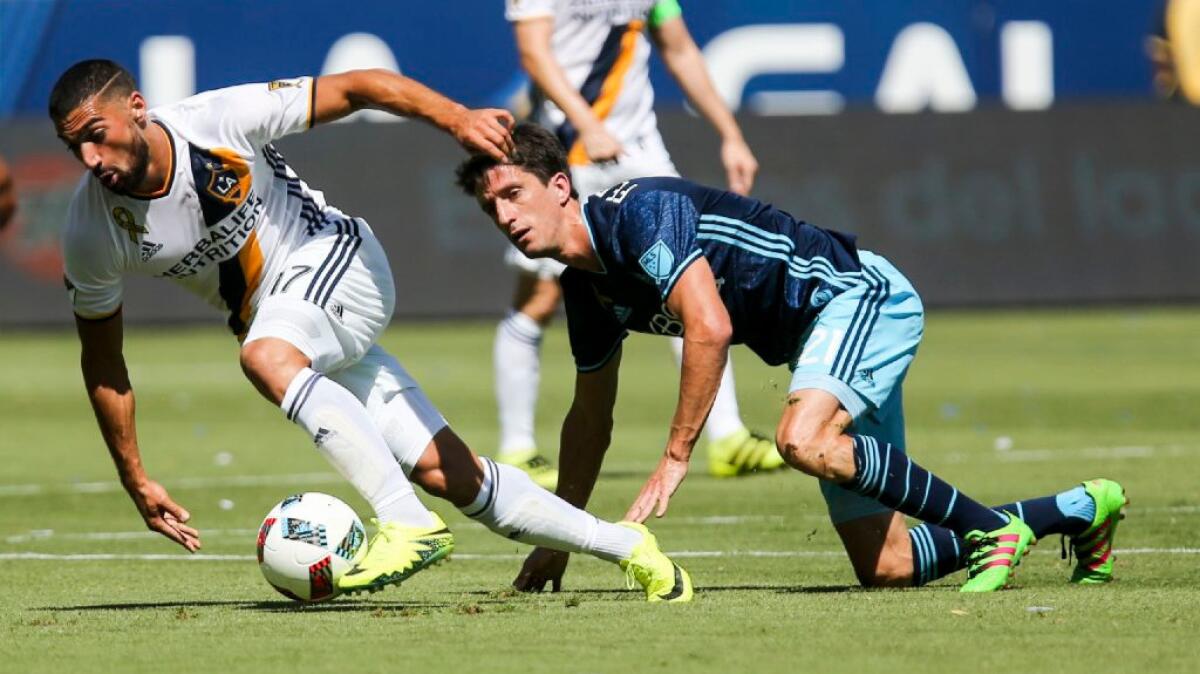 Galaxy midfielder Sebastian Lletget and Sounders midfielder Alvaro Fernandez, right, battle for the ball during the first half of a game on Sept. 25.