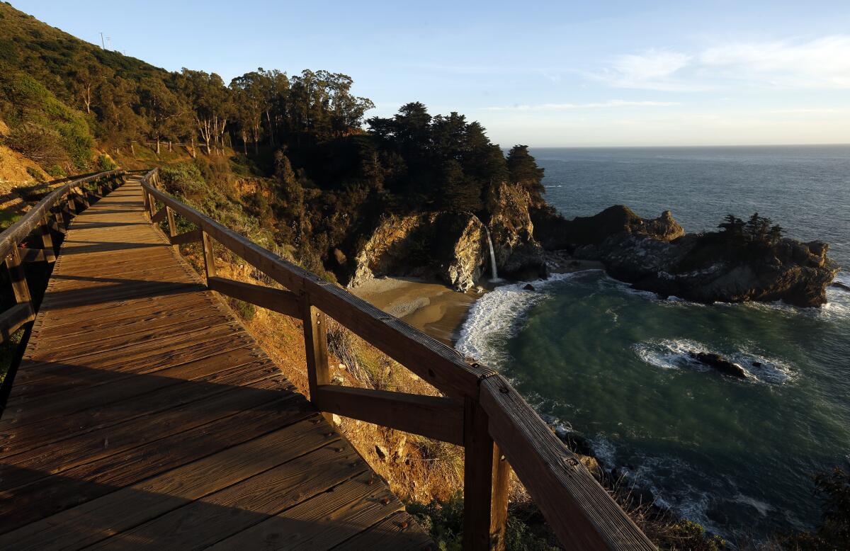 With Highway One and Julia Pfeiffer Burns State Park closed to the public, a walkway overlooking the park's famous waterfall is deserted. On a normal afternoon, the site would be crowded with visitors from around the world.