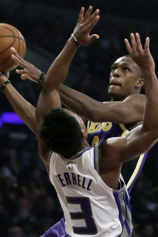 Lakers guard Rajon Rondo, right, shoots over Sacramento Kings guard Yogi Ferrell.