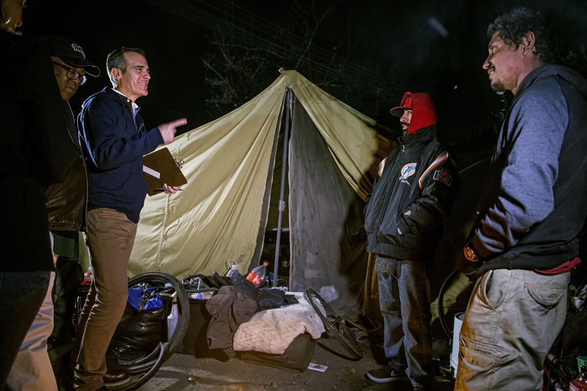 Mayor Eric Garcetti, joined by L.A. County Supervisor Mark Ridley-Thomas, talks with Manny Munoz and Ricardo Seleuco as they count homeless people on Jan. 22, 2019.