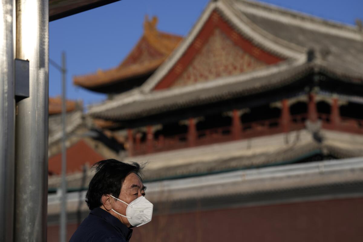 A resident wears a mask near the Lama Temple in Beijing.