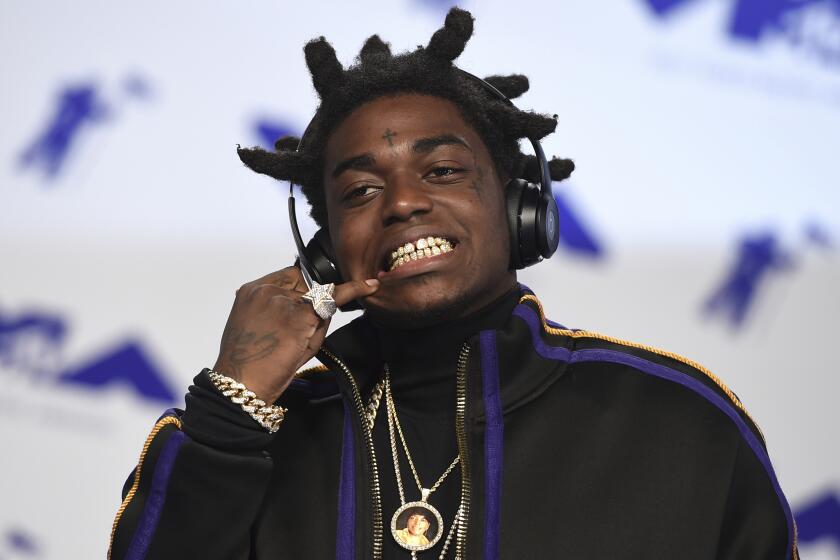 FILE - In this Aug. 27, 2017 file photo, Kodak Black arrives at the MTV Video Music Awards in Inglewood, Calif. The rapper has been sentenced to more than three years in federal prison after pleading guilty to weapons charges stemming from his arrest just before a scheduled concert performance in May. The 22-year-old admitted in August that he falsified information on federal forms to buy four firearms from a Miami-area gun shop on two separate occasions. (Photo by Jordan Strauss/Invision/AP, File)