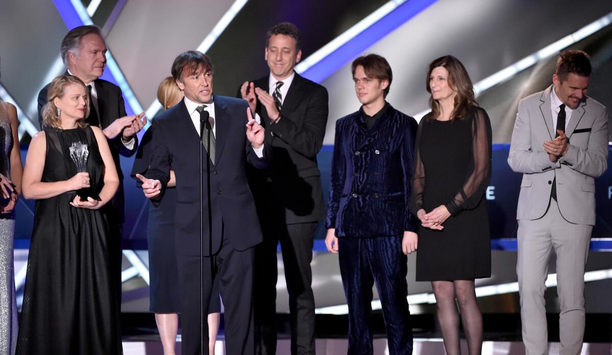From left, producer Cathleen Sutherland, producer Jonathan Sehring, actress Patricia Arquette, director/writer Richard Linklater, producer John Sloss, actor Ellar Coltrane, editor Sandra Adair, and actor Ethan Hawke accept the picture award for "Boyhood."