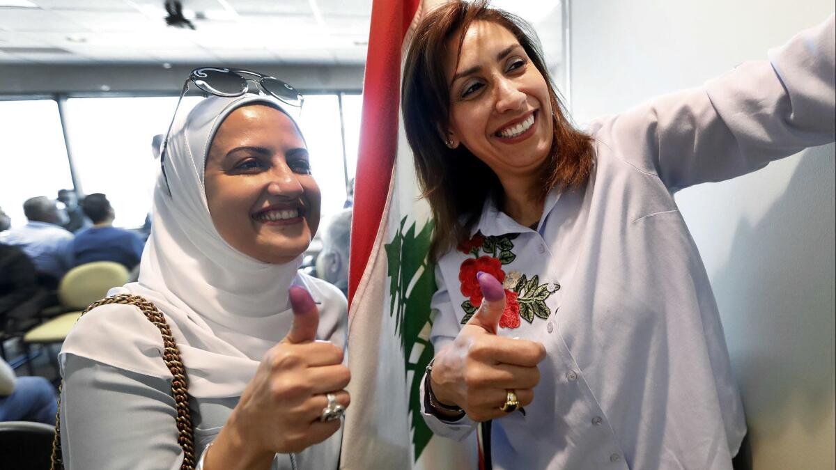 A new law allows Lebanese expatriates to vote in their nation's parliamentary elections. Roba Chanti, left, and her cousin Tala voted at the Lebanese Consulate in Southfield, Mich., on April 29, 2018.