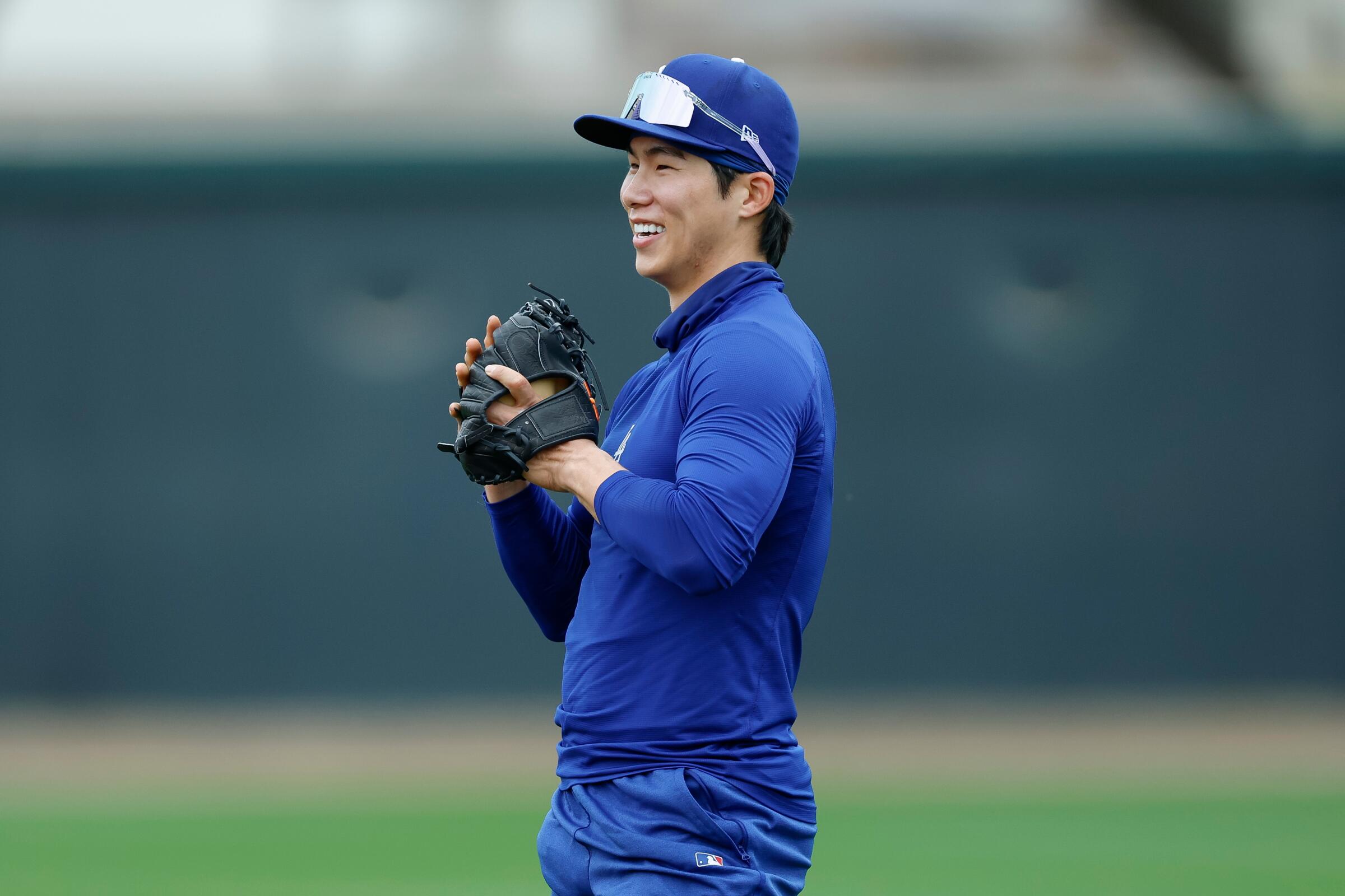 The Dodgers' Hyeseong Kim participates in a fielding drill during spring training workouts at Camelback Ranch on Friday.