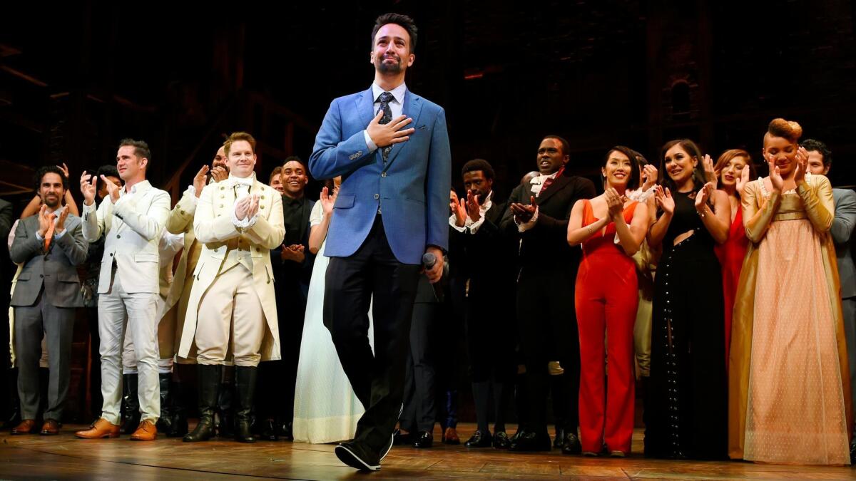 "Hamilton" creator Lin-Manuel Miranda, center, with members of the musical's touring company last week at the Hollywood Pantages.