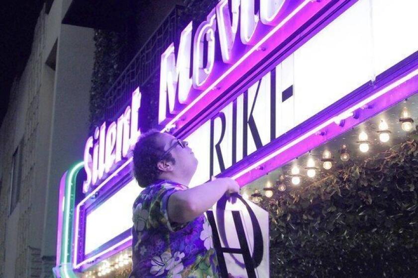 Mark Ayala puts up the movie title on the marquee before the midnight showing of the movie "Riki-Oh" at the Cinefamily on Fairfax Avenue in Los Angeles on April 26, 2013.