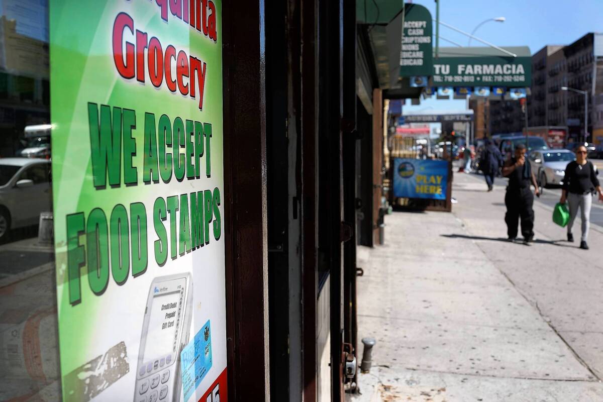 A store advertises it accepts food stamps