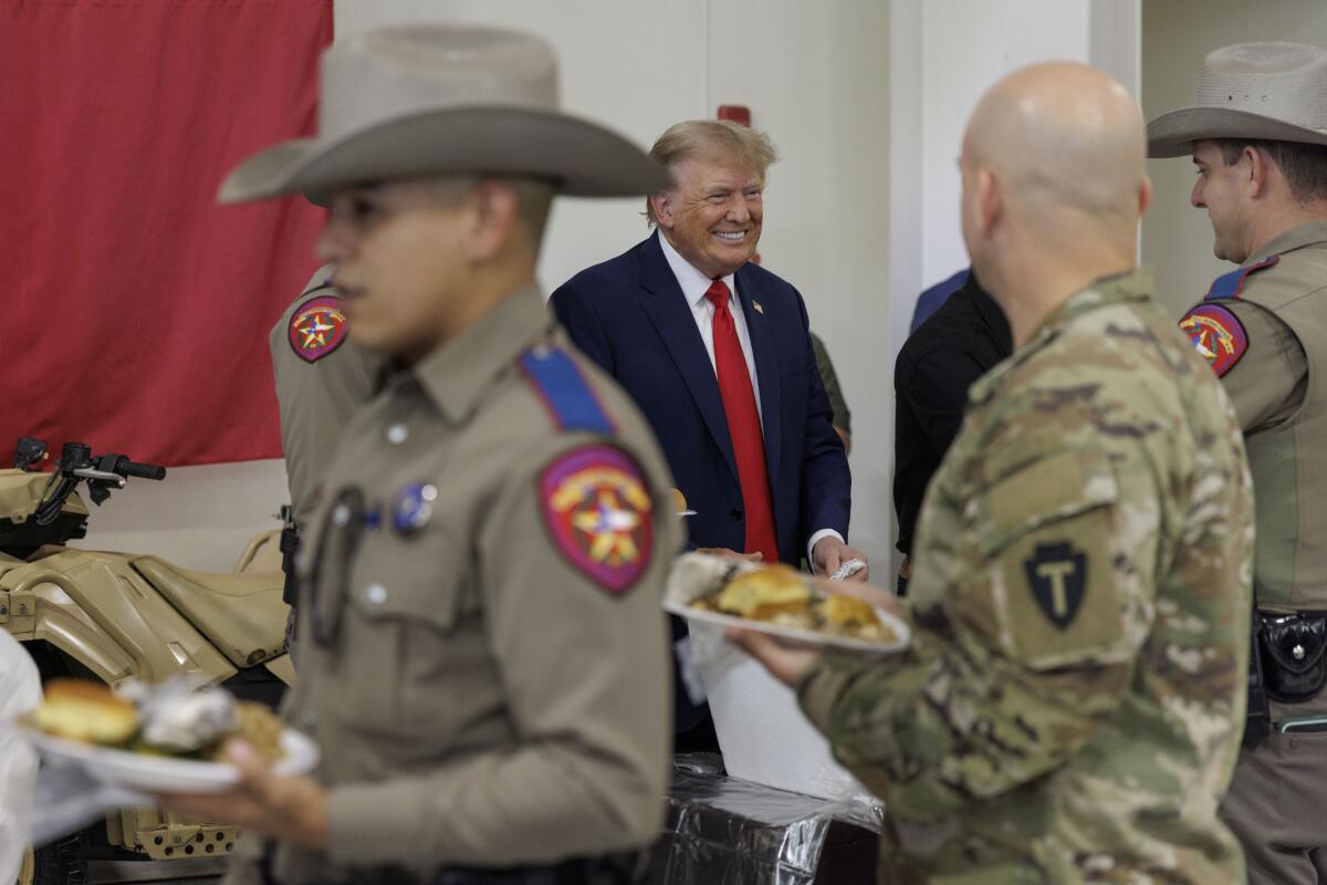 Donald Trump with a line of uniformed officers, some in cowboy hats