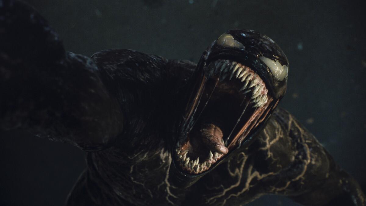 A CGI monster opening its mouth full of sharp teeth and a long, pointy tongue