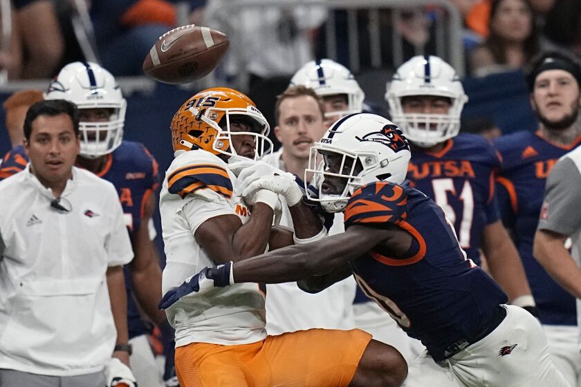 UTSA cornerback Nicktroy Fortune, right, breaks up a pass intended for UTEP wide receiver Kelly Akharaiyi, front left, during the first half of an NCAA college football game in San Antonio, Saturday, Nov. 26, 2022. (AP Photo/Eric Gay)