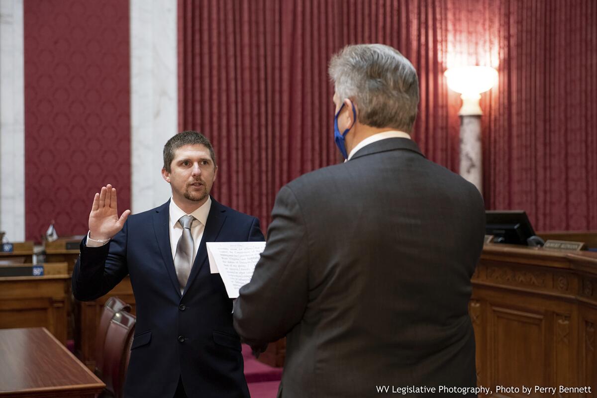Derrick Evans is given the oath of office in the West Virginia House of Delegates on Dec. 14, 2020.