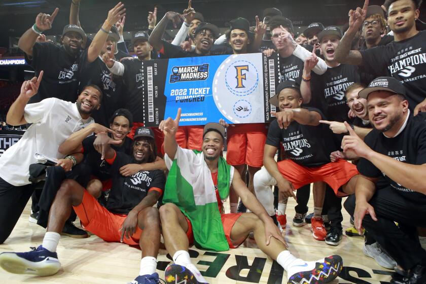 Cal State Fullerton celebrates an NCAA college basketball game against Long Beach State.