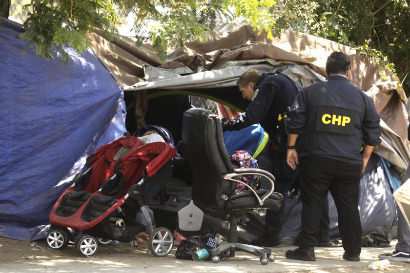 VAN NUYS, CA - JUNE 14, 2022 - - CHP officers investigate the site where a man, accused of shooting and seriously injuring a California Highway Patrol officer during a traffic stop in Studio City, was arrested at a homeless encampment along Gloria Avenue in Van Nuys on June 14, 2022. Pejhmaun Iraj Khosroabadi, 33, was considered armed and dangerous before he was found hiding inside a tent on Gloria Avenue in Van Nuys. (Genaro Molina / Los Angeles Times)