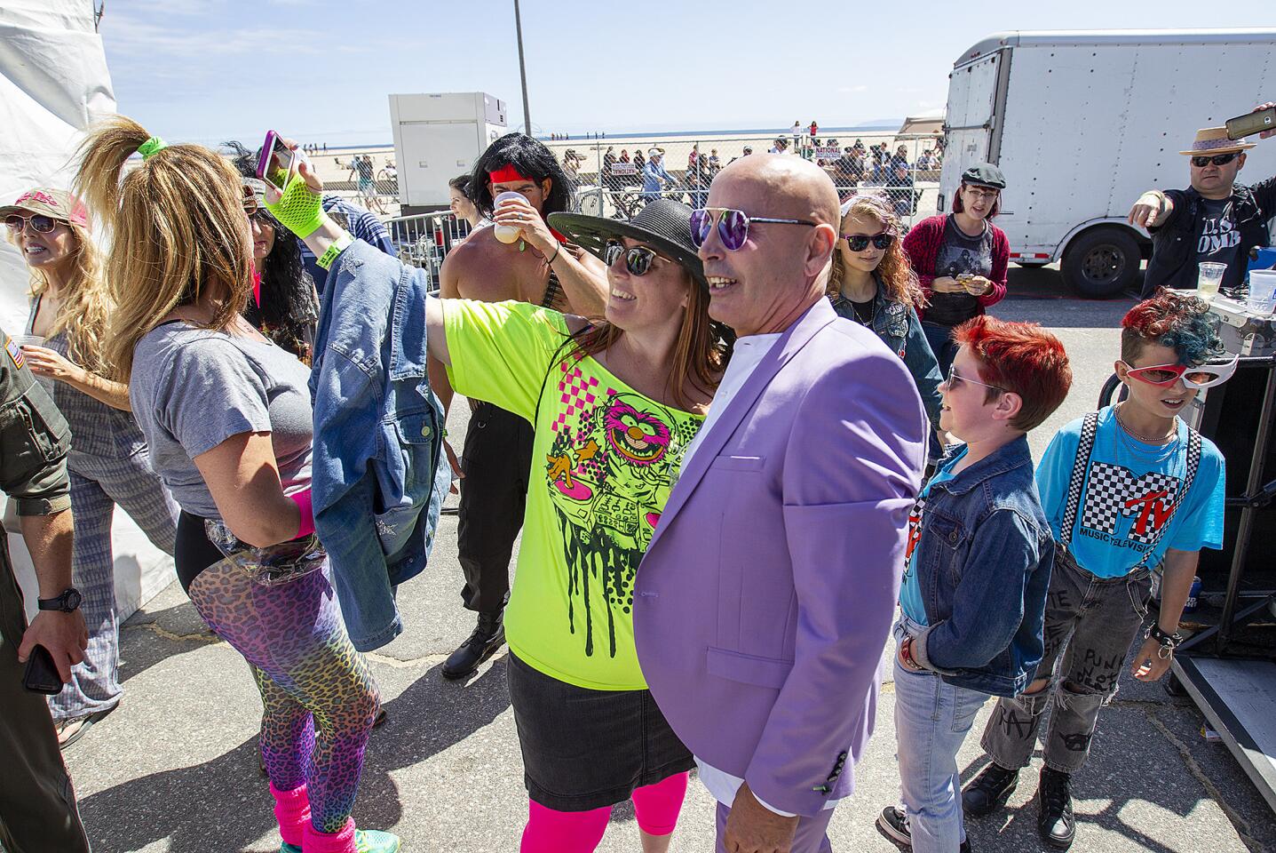 Sona Frampton takes a selfie with Clive Farrington during the Third Annual Like Totally Festival at Huntington State Beach on Saturday, May 12.