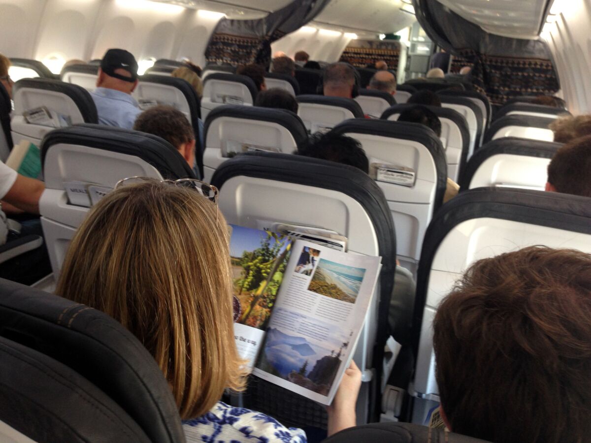 Passengers pass the time on an Alaska Airlines flight in August 2014.