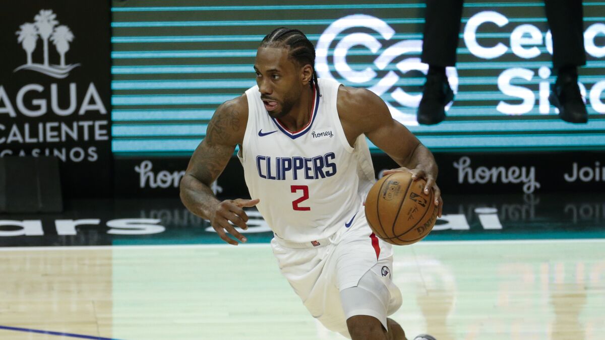 The Clippers' Kawhi Leonard drives against the Orlando Magic on March 30, 2021.