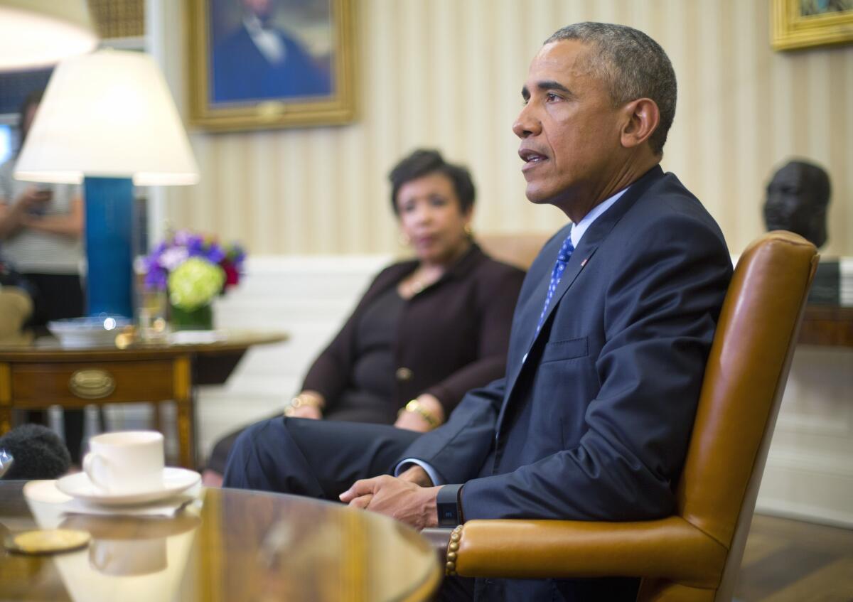 Atty. Gen. Loretta Lynch listens to President Obama in the Oval Office on Monday during a discussion on executive actions the president can take to curb gun violence.
