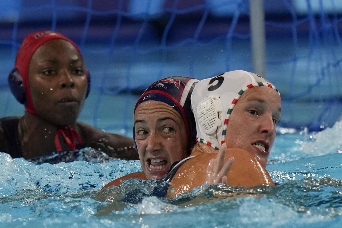 Hungary's Geraldine Mahieu battles for the ball with American Maggie Steffens during a quarterfinal water polo match