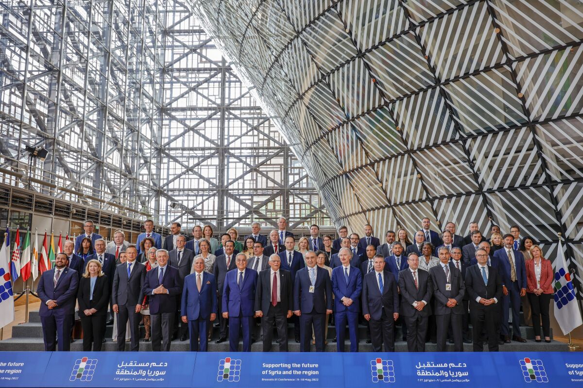European Union foreign policy chief Josep Borrell, center red tie, and the attending dignitaries of the meeting, Supporting the future of Syria and the region, pose for the group photo at the European Council building in Brussels, Tuesday, May 10, 2022. (AP Photo/Olivier Matthys)