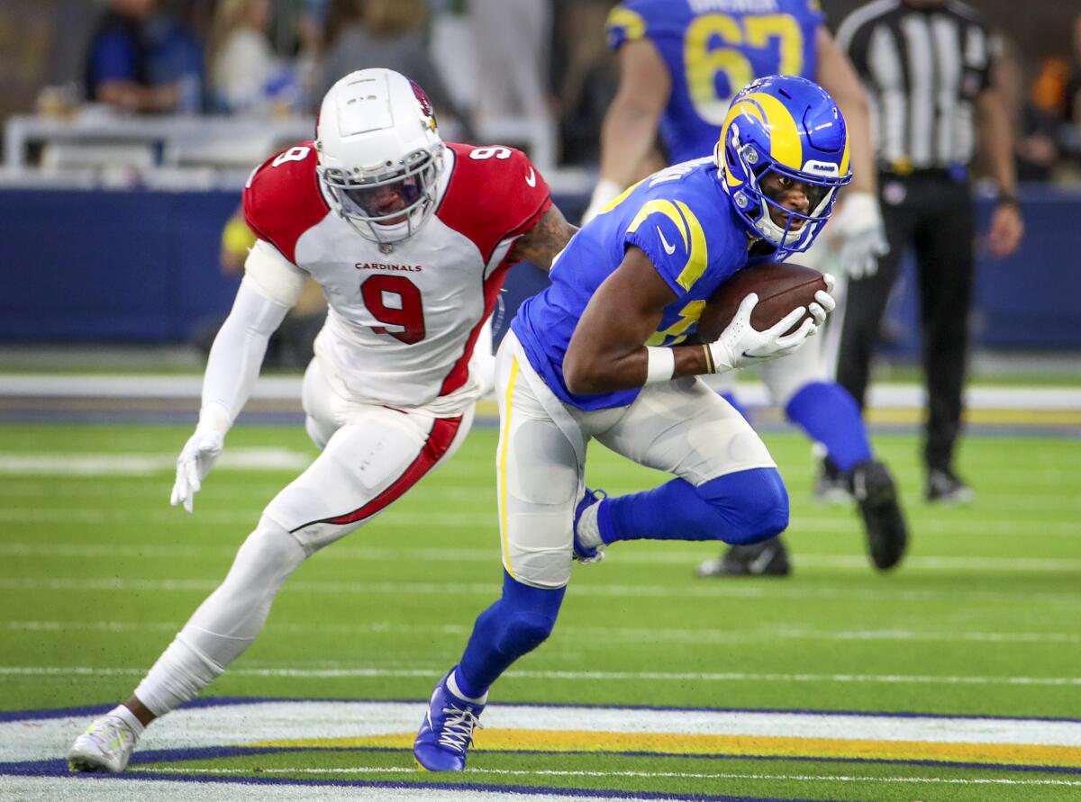 Rams wide receiver Van Jefferson catches a pass in front of Cardinals inside linebacker Isaiah Simmons at SoFi Stadium.