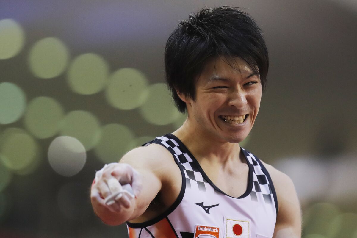 FILE - Silver medalist Kohei Uchimura of Japan celebrates after his horizontal bar performance on the second and last day of the apparatus finals of the Gymnastics World Championships at the Aspire Dome in Doha, Qatar on Nov. 3, 2018. Three-time Olympic gold medal gymnast Kohei Uchimura of Japan, the man they call “King Kohei,” is retiring, his management company said Tuesday, Jan. 11, 2022. (AP Photo/Vadim Ghirda, FIle)
