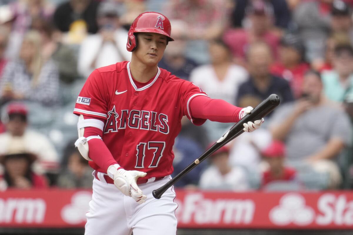 Angels star Shohei Ohtani tosses his bat after striking out in the first inning against the Miami Marlins.