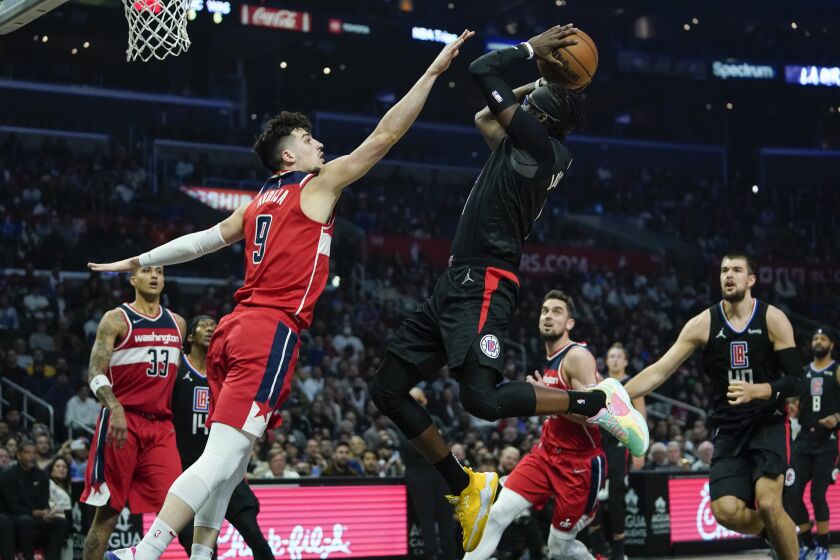 LA Clippers guard Reggie Jackson (1) shoots against Washington Wizards forward Deni Avdija (9) during the first half of an NBA basketball game in Los Angeles, Wednesday, March 9, 2022. (AP Photo/Ashley Landis)