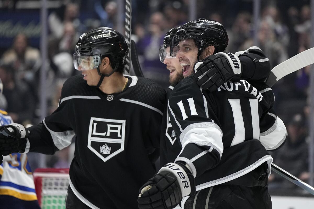 The Kings' Adrian Kempe, middle, celebrates his second-period goal with Quinton Byfield, left, and Anze Kopitar.