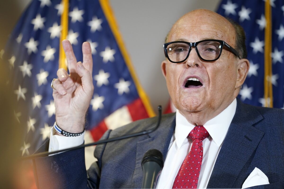 FILE - Former Mayor of New York Rudy Giuliani, a lawyer for President Donald Trump, speaks during a news conference at the Republican National Committee headquarters, Thursday Nov. 19, 2020, in Washington. President Donald Trump says his personal attorney Rudy Giuliani has tested positive for coronavirus. The president on Sunday, Dec. 6, 2020 confirmed in a tweet that Giuliani had tested positive for the virus. Giuliani has traveled extensively to battleground states in effort to help Trump subvert his election loss. (AP Photo/Jacquelyn Martin, file)